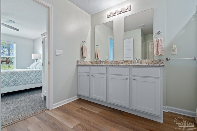 10985 Blacktail Loop, Pensacola, FL 32526 - ensuite bathroom with wood finished floors, baseboards, double vanity, and ceiling fan