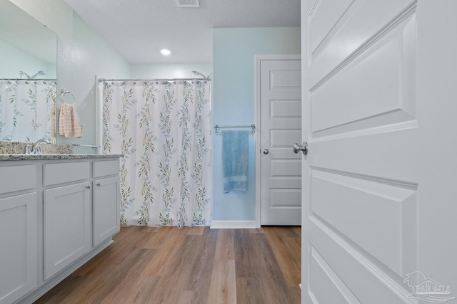 10985 Blacktail Loop, Pensacola, FL 32526 - full bath featuring wood finished floors, vanity, a shower with curtain, and recessed lighting