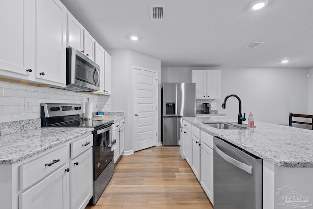 10985 Blacktail Loop, Pensacola, FL 32526 - kitchen with stainless steel appliances, a sink, decorative backsplash, an island with sink, and recessed lighting