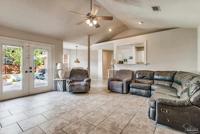 tiled living room featuring french doors, vaulted ceiling, a textured ceiling, and ceiling fan