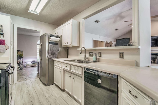 kitchen featuring white cabinetry, a textured ceiling, light wood-type flooring, black appliances, and sink