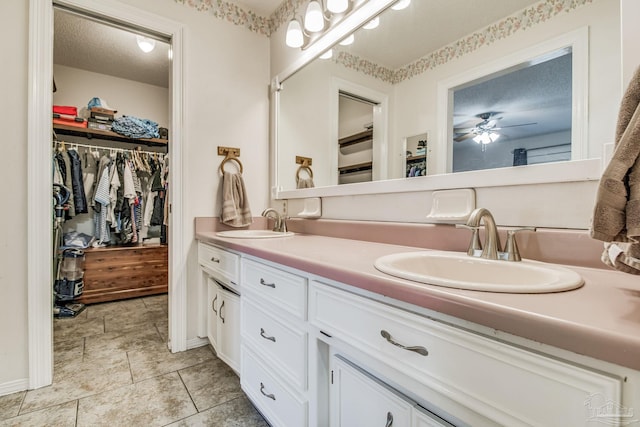 bathroom with vanity, a textured ceiling, and ceiling fan