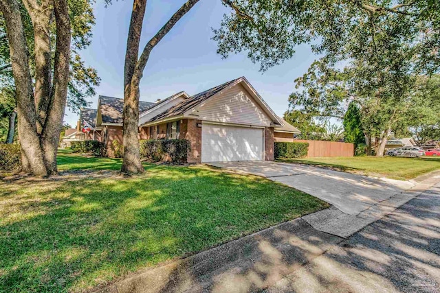 ranch-style house featuring a front lawn and a garage