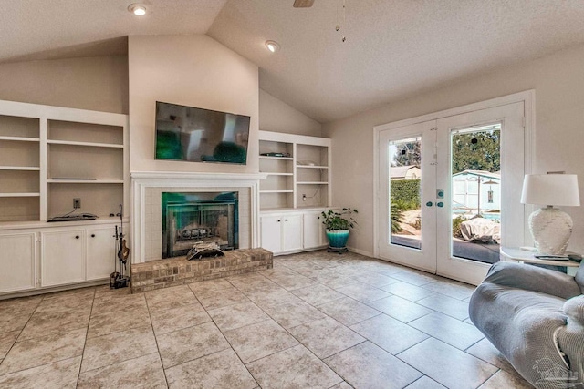 unfurnished living room featuring french doors, a textured ceiling, vaulted ceiling, and a brick fireplace