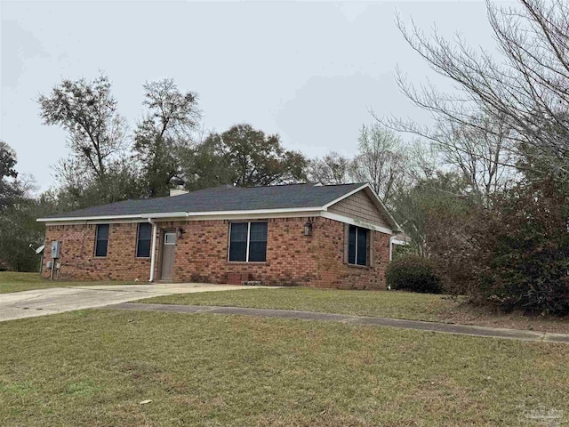 single story home with a front yard, brick siding, and driveway