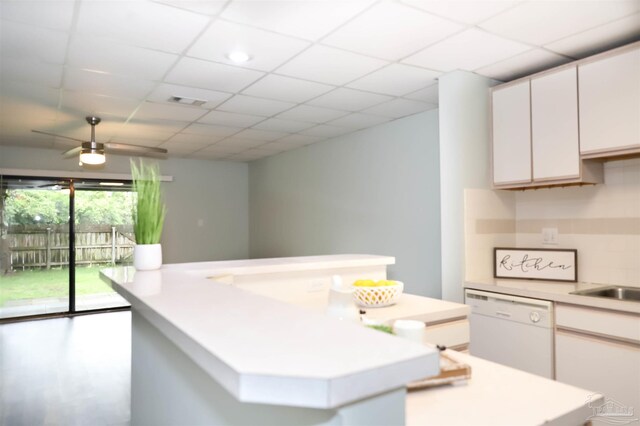 kitchen with white cabinetry, ceiling fan, dishwasher, a center island, and a paneled ceiling