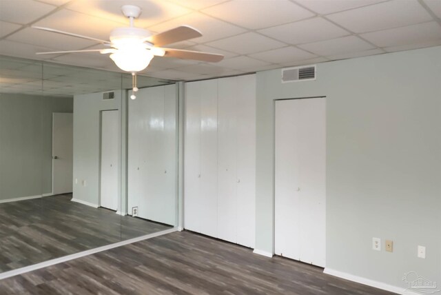 unfurnished bedroom featuring a paneled ceiling, ceiling fan, and hardwood / wood-style flooring