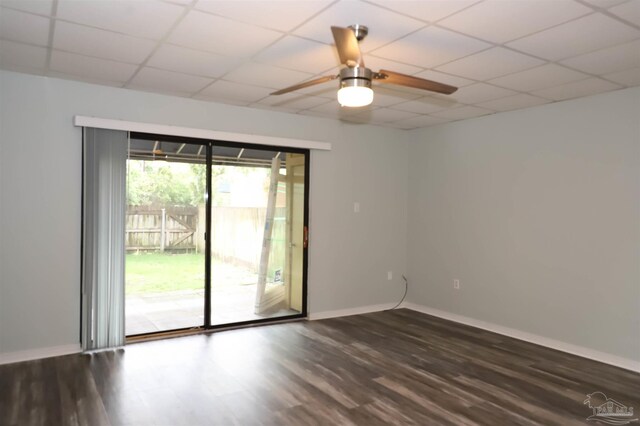 spare room featuring ceiling fan, a paneled ceiling, and hardwood / wood-style flooring