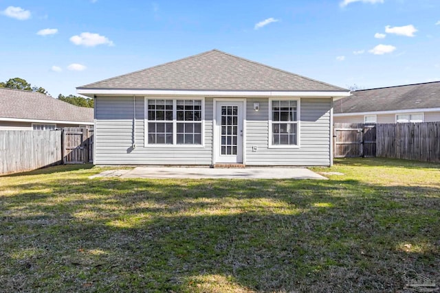 rear view of house featuring a yard and a patio area