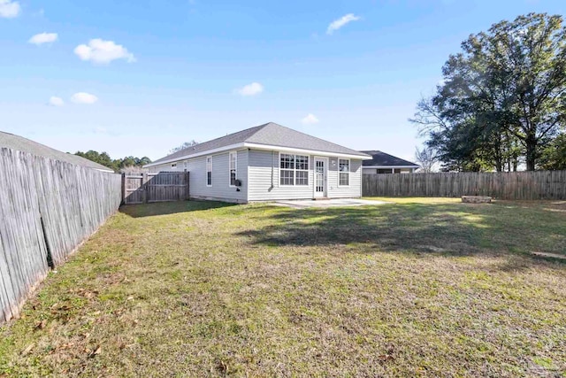 rear view of property with a yard and a patio