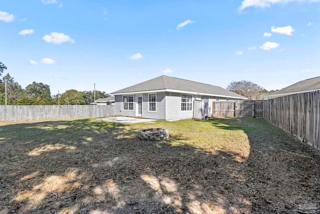 back of property featuring an outdoor fire pit, a yard, and a patio area