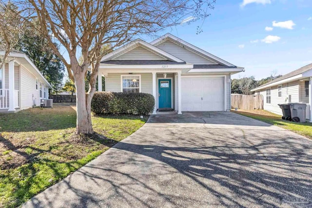 view of front of house featuring a garage, a front yard, and central AC unit