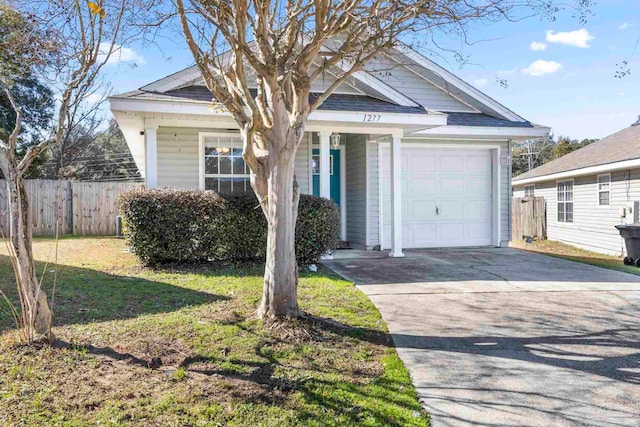 view of front of property featuring a garage and a front lawn