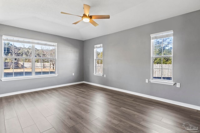 spare room featuring lofted ceiling, dark hardwood / wood-style floors, and ceiling fan