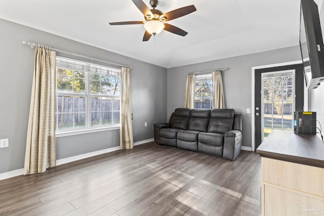 living room featuring hardwood / wood-style flooring, ceiling fan, and lofted ceiling