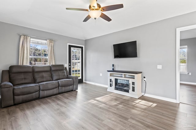 living room featuring hardwood / wood-style flooring and ceiling fan