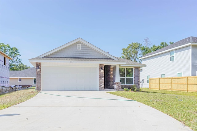 view of front of property with a front yard and a garage