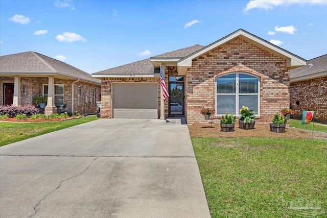 3966 Willow Glen Dr, Pace, FL 32571 - ranch-style house featuring a garage, a front yard, concrete driveway, and brick siding