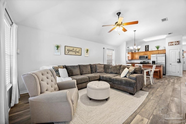 3966 Willow Glen Dr, Pace, FL 32571 - living area featuring light wood finished floors, visible vents, ceiling fan with notable chandelier, and lofted ceiling