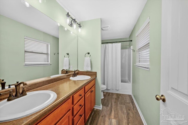 3966 Willow Glen Dr, Pace, FL 32571 - full bath with toilet, wood finished floors, a sink, and visible vents