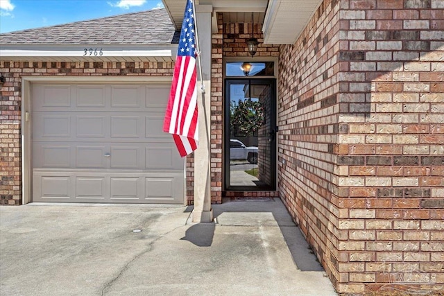 3966 Willow Glen Dr, Pace, FL 32571 - property entrance with concrete driveway, brick siding, a garage, and a shingled roof