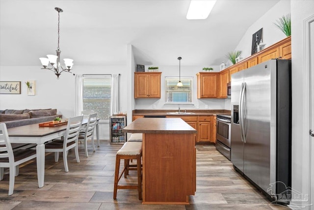 3966 Willow Glen Dr, Pace, FL 32571 - kitchen with beverage cooler, a healthy amount of sunlight, an inviting chandelier, and stainless steel appliances