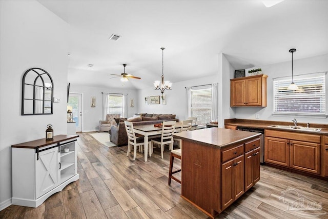 3966 Willow Glen Dr, Pace, FL 32571 - kitchen featuring visible vents, wood finished floors, dishwasher, a sink, and dark countertops