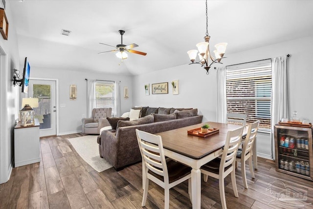 3966 Willow Glen Dr, Pace, FL 32571 - dining space featuring wood finished floors, ceiling fan with notable chandelier, baseboards, and beverage cooler