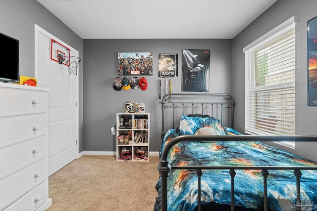 carpeted bedroom featuring baseboards