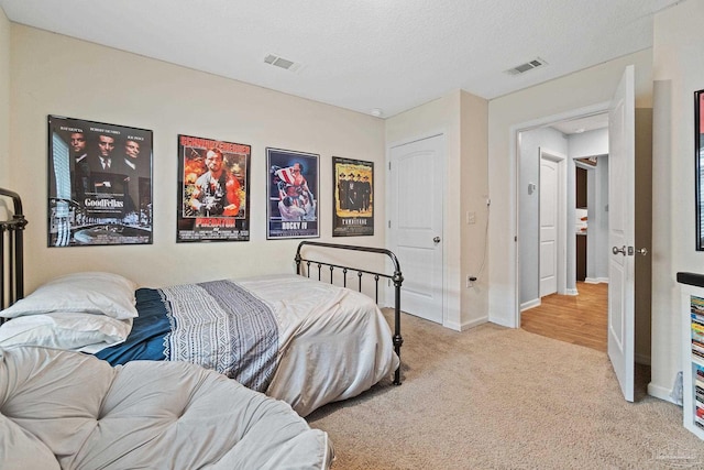 bedroom with carpet, visible vents, and baseboards