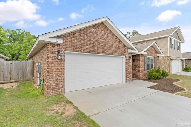view of front of home featuring fence, driveway, an attached garage, and brick siding