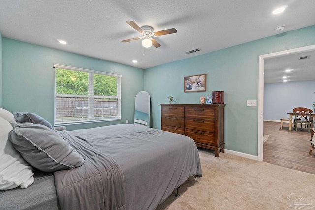 bedroom with recessed lighting, a textured ceiling, and visible vents