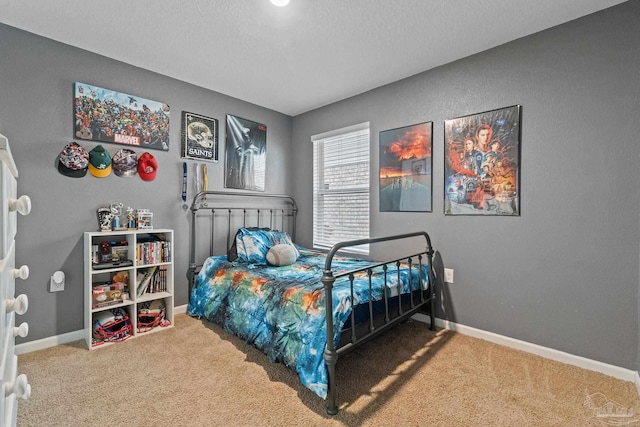 carpeted bedroom featuring baseboards