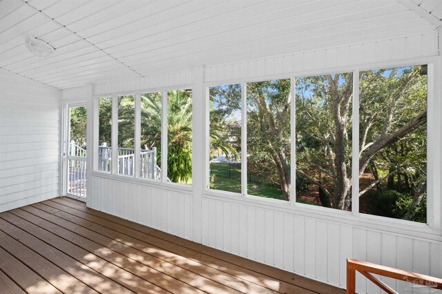 unfurnished sunroom with a healthy amount of sunlight and vaulted ceiling