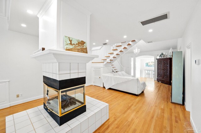 interior space with light hardwood / wood-style floors and a tiled fireplace