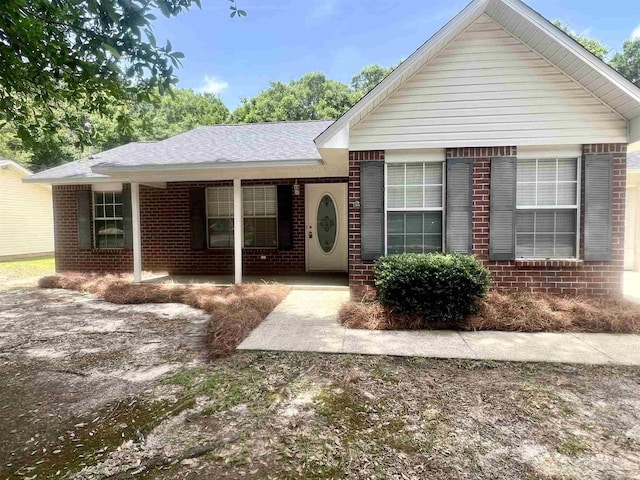 5538 Rowell Rd, Milton, FL 32583 - ranch-style home with brick siding, a porch, and a shingled roof