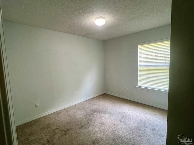 5538 Rowell Rd, Milton, FL 32583 - empty room with carpet flooring, a textured ceiling, and baseboards