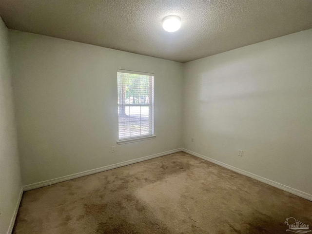 5538 Rowell Rd, Milton, FL 32583 - carpeted spare room featuring baseboards and a textured ceiling