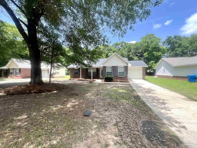 5538 Rowell Rd, Milton, FL 32583 - single story home featuring brick siding, concrete driveway, covered porch, and a garage