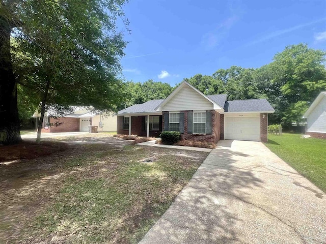 5538 Rowell Rd, Milton, FL 32583 - single story home featuring a garage, concrete driveway, brick siding, and a front lawn