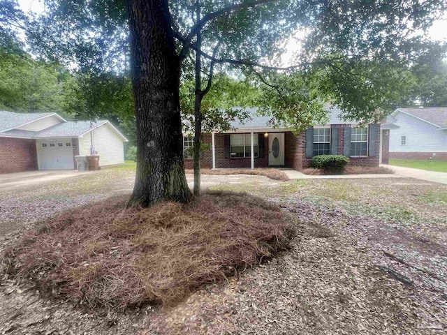 5538 Rowell Rd, Milton, FL 32583 - ranch-style house featuring brick siding, a garage, and driveway