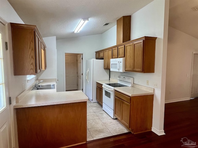 5538 Rowell Rd, Milton, FL 32583 - kitchen with white appliances, a sink, brown cabinets, light countertops, and lofted ceiling