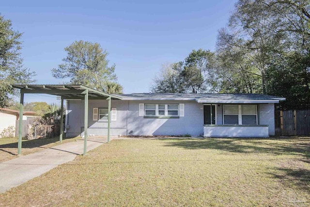 single story home with an attached carport, concrete block siding, fence, concrete driveway, and a front lawn
