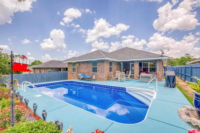 view of swimming pool with a hot tub and a patio