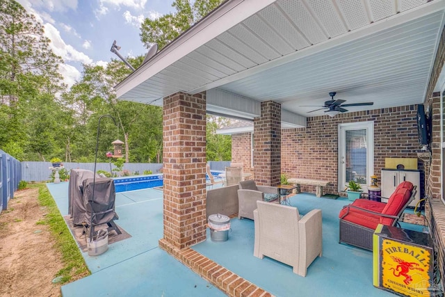 view of patio / terrace featuring a fenced in pool, an outdoor living space, and ceiling fan