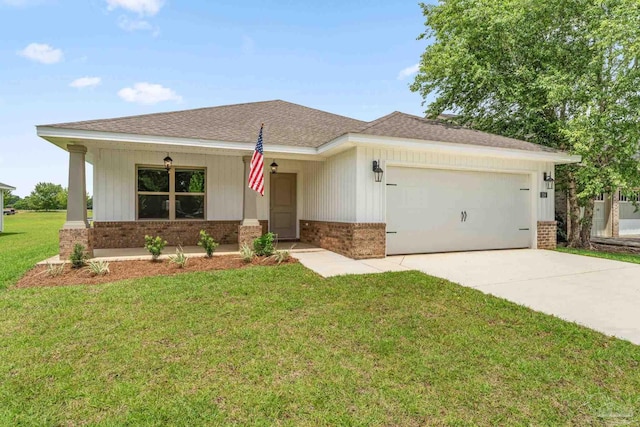 view of front of property with a front yard and a garage