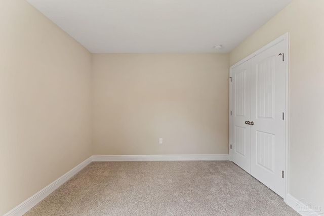 empty room featuring light colored carpet