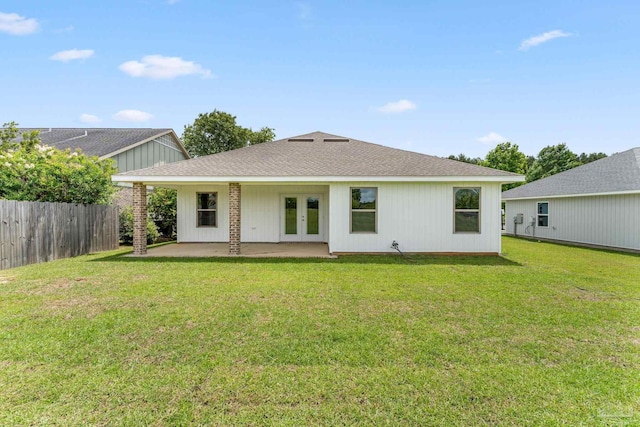 rear view of property with a patio and a lawn