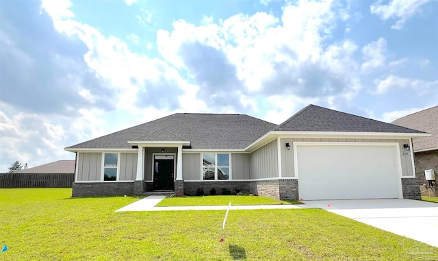 view of front of home featuring a front lawn and a garage