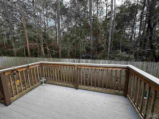 wooden terrace featuring a fenced backyard